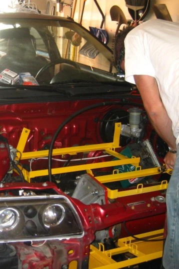 A battery rack being installed into an EV
