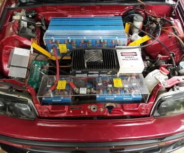 The open hood of a homemade Honda CRX electric car