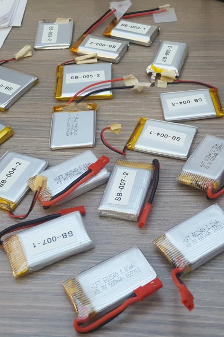 Dozens of small lithium polymer batteries on a workbench
